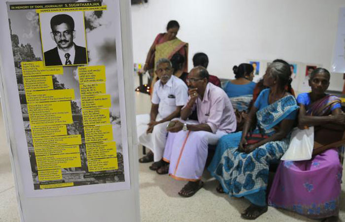 A poster showing a portrait of slain ethnic Tamil journalist S. Sugirtharajan is pasted on a wall as people await to place their signatures during a petition signing demanding that Sirisena appoint a presidential commission to investigate all abductions during the country’s brutal, decades-long civil war, in Colombo, Sri Lanka, on Tuesday. — AP