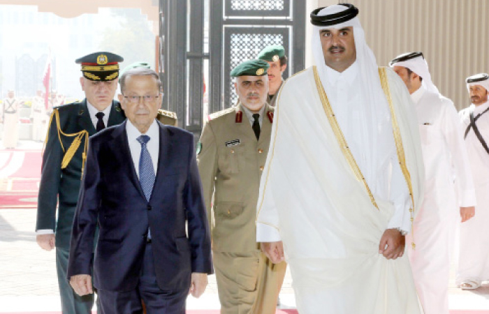 Emir of Qatar Sheikh Tamim Bin Hamad Al-Thani (right) welcomes Lebanese President Michel Aoun upon his arrival in Doha, Wednesday. — AFP