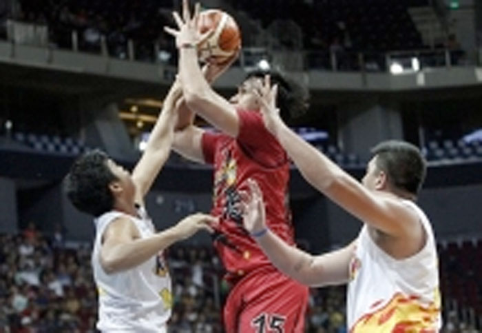 San Miguel Beer’s June Mar Fajardo fires a shot despite being sandwiched by the defense of Don Trollano and Beau Belga of Rain or Shine in their PBA Philippine Cup match at the Mall of Asia Arena Friday night.