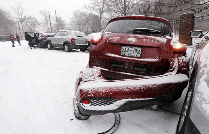 Cars involved in accidents due to snow and ice sit on the side of a road in Nashville, Tennessee, on Friday. — AP