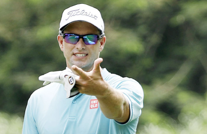 Adam Scott of Australia gestures on the fairway of the 3rd hole during the SMBC Singapore Open golf tournament at Sentosa Golf Club’s Serapong Course on Saturday in Singapore. — AP