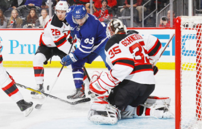 Damon Severson (L) and Cory Schneider (R) of the New Jersey Devils defend against Nazem Kadri of the Toronto Maple Leafs during their NHL game at the Prudential Center in Newark Friday. — AFP