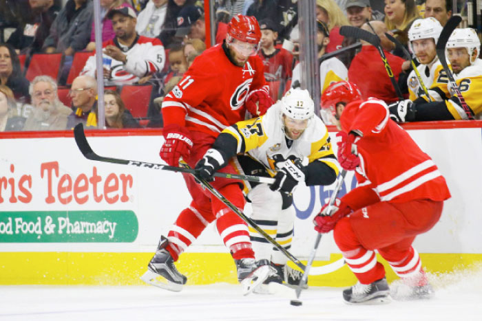 Carolina Hurricanes forward Jordan Staal (11) checks Pittsburgh Penguins forward Bryan Rust (17) off the puck at PNC Arena. The Pittsburgh Penguins defeated the Carolina Hurricanes 7-1. — Reuters