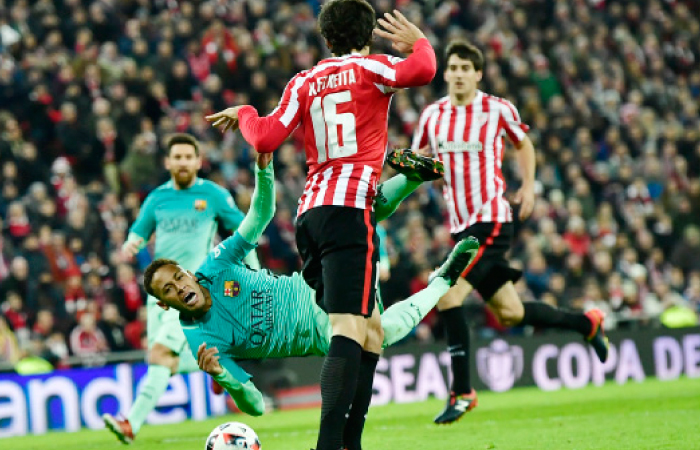 Barcelona’s Neymar falls to the ground as he vies for the ball with Athletic Bilbao’s Xabier Etxeita during their Spanish Copa del Rey match in Bilbao, northern Spain, Thursday. - AP