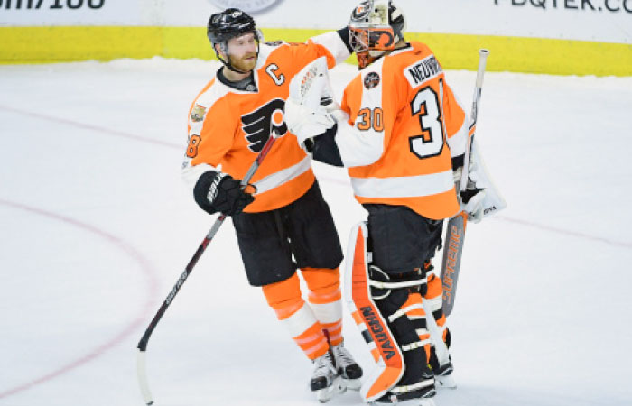Philadelphia Flyers’ center Claude Giroux (L) celebrates with goalie Michal Neuvirth after winning their NHL game against Vancouver Canucks at Wells Fargo Center in Philadelphia Thursday. — Reuters