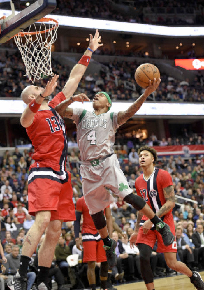 Boston Celtics’ guard Isaiah Thomas (No. 4) goes to the basket against Washington Wizards’ center Marcin Gortat (No. 13) and forward Kelly Oubre Jr. (No. 12) during the second half of their NBA game in Washington Tuesday. - AP