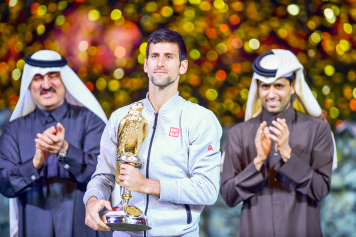 Novak Djokovic of Serbia celebrates with his trophy after winning his Qatar Open 2017 final tennis match against Britain's Andy Murray in Doha, Qatar. — AP