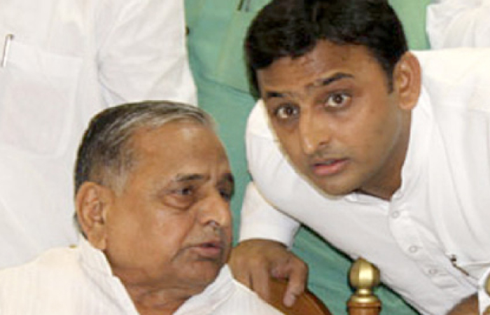 A file photo shows Mulayam Singh Yadav, left, speaking to his son and chief minister of Uttar Pradesh Akhilesh Yadav. — AFP