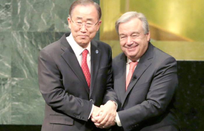 Former United Nations Secretary-General Ban Ki-moon, left, clasps hands with UN Secretary-General Antonio Guterres at UN headquarters in this Dec. 12, 2016 file photo. — AP