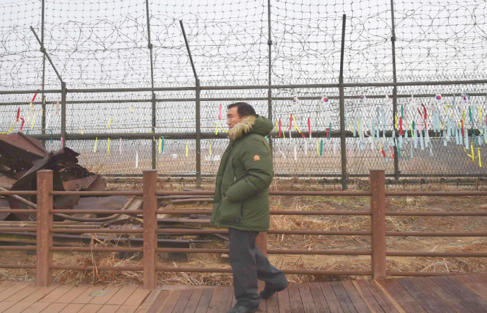 A man walks past a military barbed wire fence at the Imjingak peace park in the border city of Paju near the Demilitarized Zone (DMZ) dividing the two Koreas on Sunday. — AFP