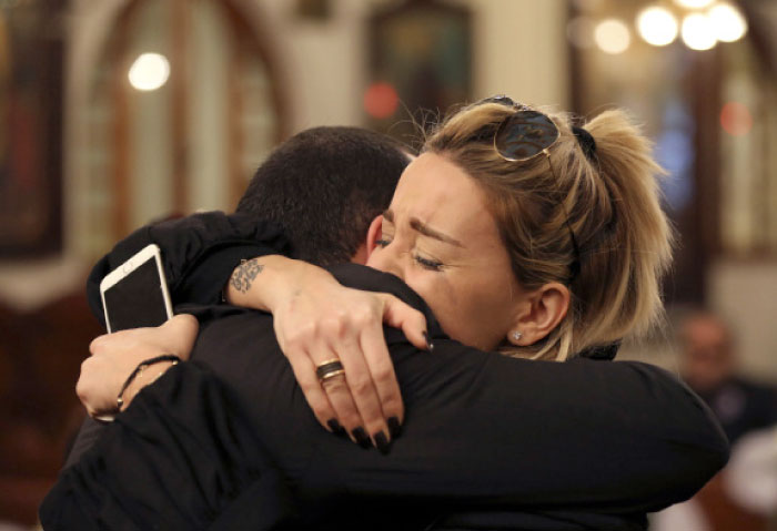 Relatives of Elias Wardini, a Lebanese man who was killed in the New Year’s Eve Istanbul nightclub attack, mourn as they comfort each other during his funeral procession, at a church in Beirut, Lebanon, Tuesday. — AP