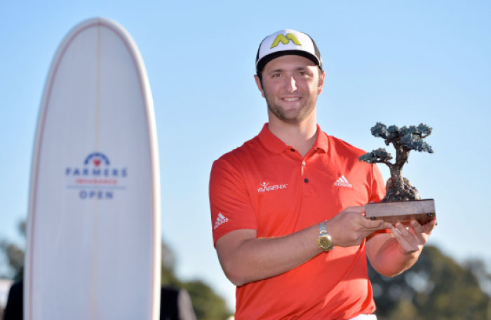 Jon Rahm poses for photographers with the winner’s trophy following the final round of the Farmers Insurance Open golf tournament at Torrey Pines Sunday. - Reuters