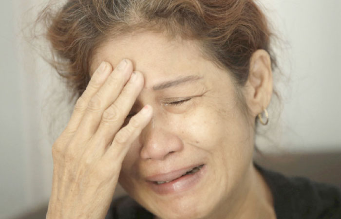 A family member weeps as she waits for the identification process of the victims of ferry fire, at the main police hospital in Jakarta, Indonesia, on Monday. — AP