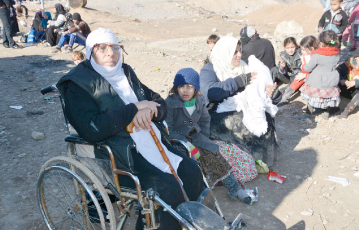 Displaced people, who fled Daesh militant violence in Mosul, gather in the town of Bartella, east of Mosul, Iraq. — Reuters