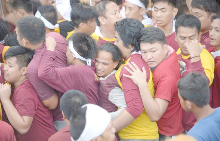 Filipino devotees jostle each other as they join the annual religious procession in Manila on Monday. — AFP