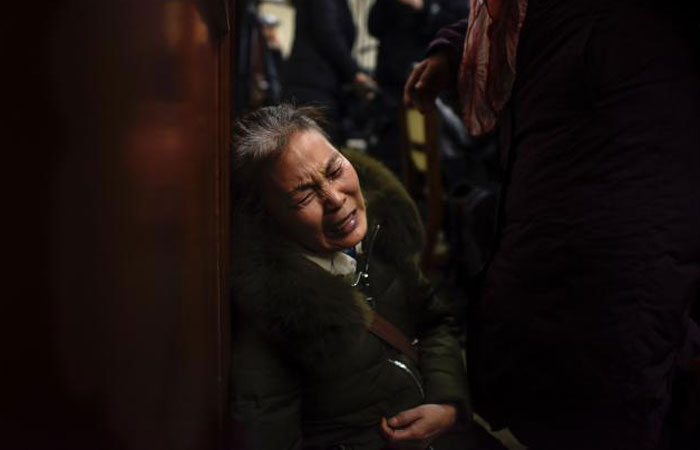 A relative of missing Chinese passengers aboard Malaysia Airlines Flight 370 that disappeared on March 8, 2014 cries before a meeting in Beijing on January 18, 2017, a day after authorities announced the end of search operations for the aircraft. — AFP