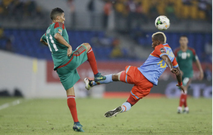 Congo’s Lomalisa Mutambala (R) vies with Morocco’s Faycal Fajr during their African Cup of Nations match in Oyem, Gabon, Monday. - AP