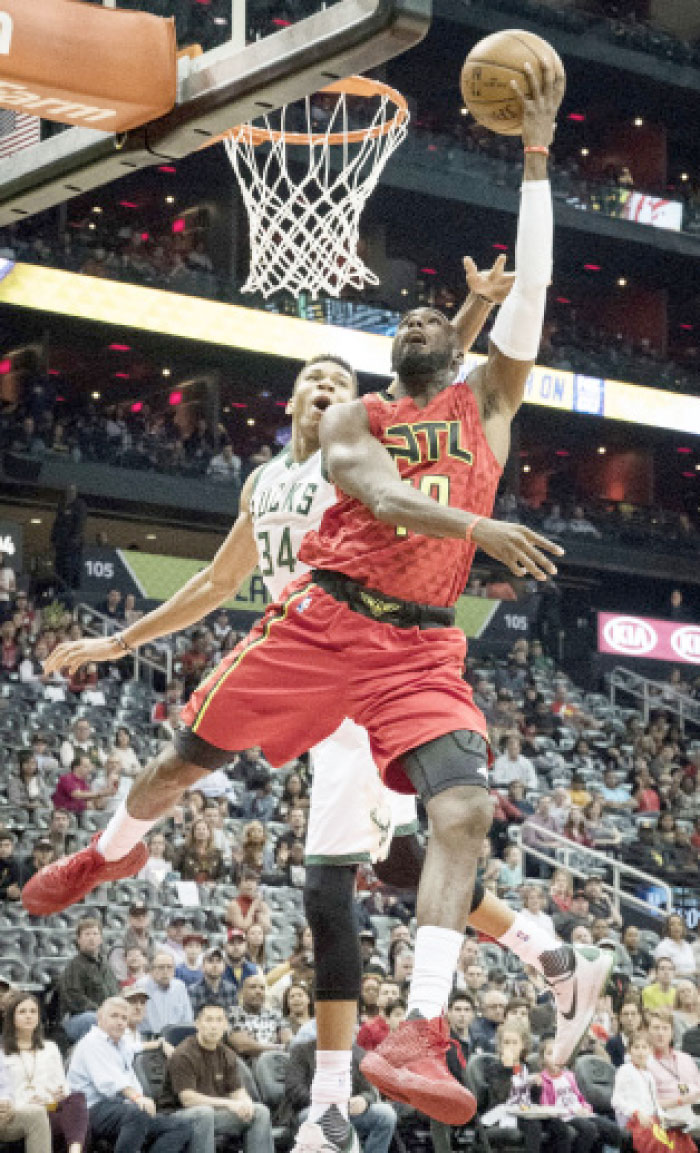 Atlanta Hawks’ guard Tim Hardaway Jr. (Front) shoots as Milwaukee Bucks’ forward Giannis Antetokounmpo (No. 34) defends in Atlanta Sunday. — AP