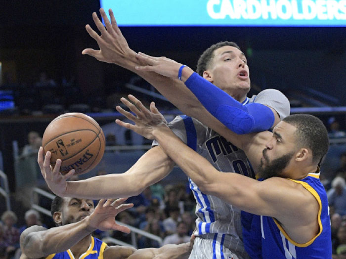 Orlando Magic’s forward Aaron Gordon is defended underneath the basket by Golden State Warriors’ forward Andre Iguodala (L) and center JaVale McGee during the second half of their NBA game in Orlando, Florida, Sunday. - AP