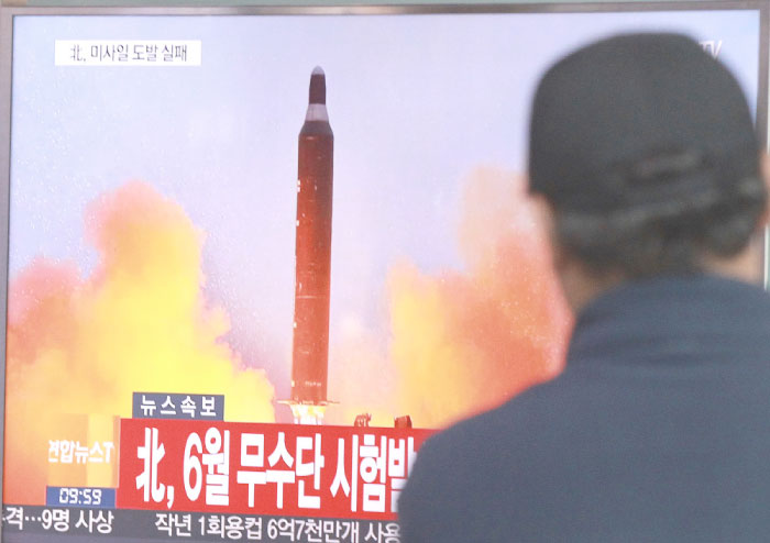 A man watches a TV news program showing a file image of a missile launch conducted by North Korea, at the Seoul Railway Station in Seoul, in this Oct. 16, 2016 file photo. — AP