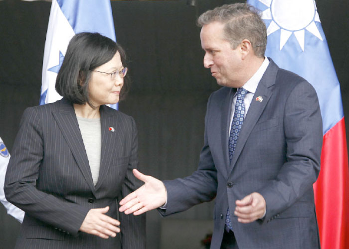 Taiwan’s President Tsai Ing-wen, left, shakes hands with First Vice President of Honduras Ricardo Alvarez after arriving at Soto Cano Air Base outside Comayagua, Honduras, on Sunday. — AP