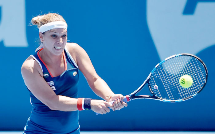 Dominika Cibulkova of Slovakia hits a return to Laura Siegemund of Germany during their women’s singles first round match at the Sydney International tennis tournament Monday. — AFP