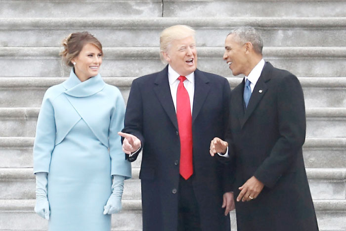 US President Donald Trump and former president Barack Obama stand on the steps of the  US Capitol with First Lady Melania Trump on January 20 in Washington. — AP