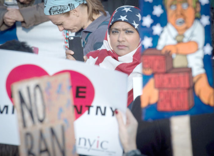 Protesters gather in Battery Park and march to the offices of Customs and Border Patrol in Manhattan to protest President Trump’s immigration ban in New York on Sunday. — AFP