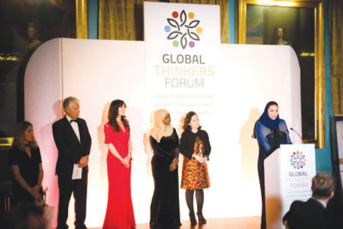 Princess Lamia Bint Majed Alsaud, Secretary General of Alwaleed Philanthropies, stands in front of the rostrum delivering her remarks after receiving the award on behalf of Prince Alwaleed