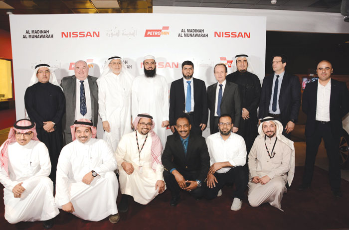 Executives of two companies pose for a group photo with some guests