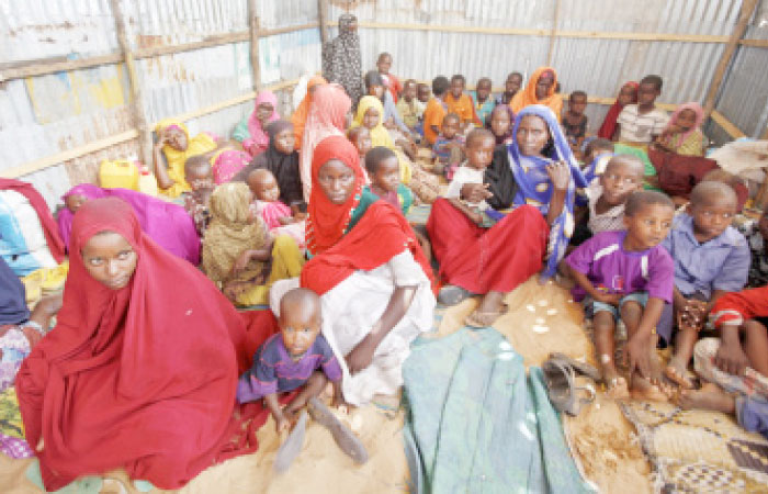 Displaced Somalis who fled the drought in southern Somalia sit in a camp in the capital Mogadishu, Somalia. — AP
