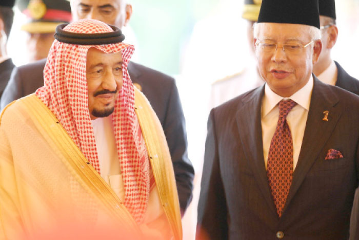 Custodian of the Two Holy Mosques King Salman talks with Malaysian Prime minister Najib Razak (R) at Parliament House in Kuala Lumpur, Sunday. — AFP