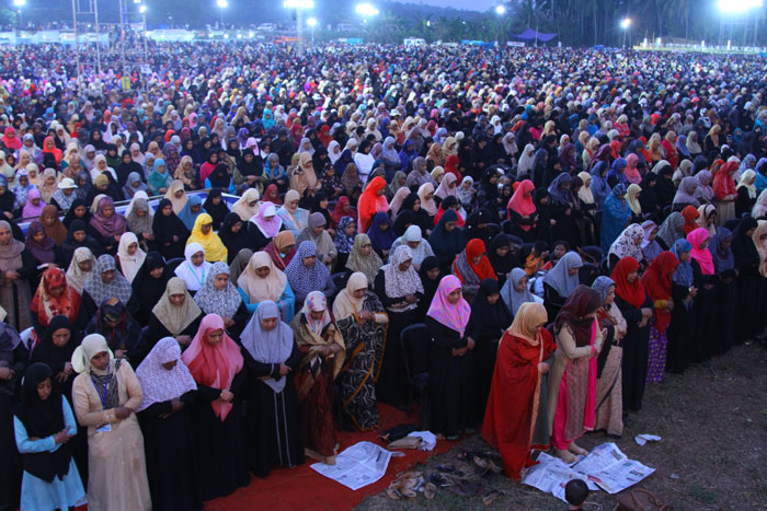 Women perform Maghreb prayer during the conference.