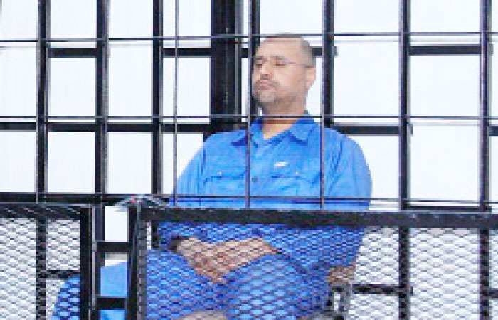 Saif Al-Islam Gaddafi, son of late Libyan leader Muammar Gaddafi, attends a hearing behind bars in a courtroom in Zintan in this file photo. — Reuters