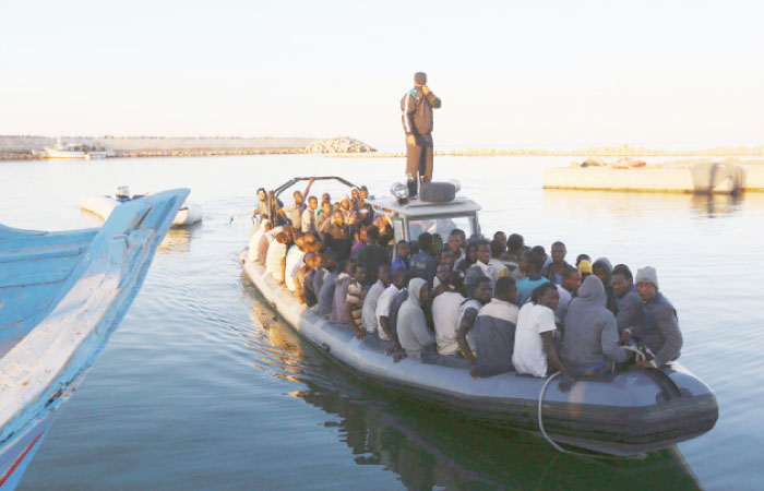 African migrants are seen seated in a boat, after being rescued by the Libyan navy following their boat suffering engine failure, near the coastal town of Gharaboli, east of Tripoli, Libya. — File photo