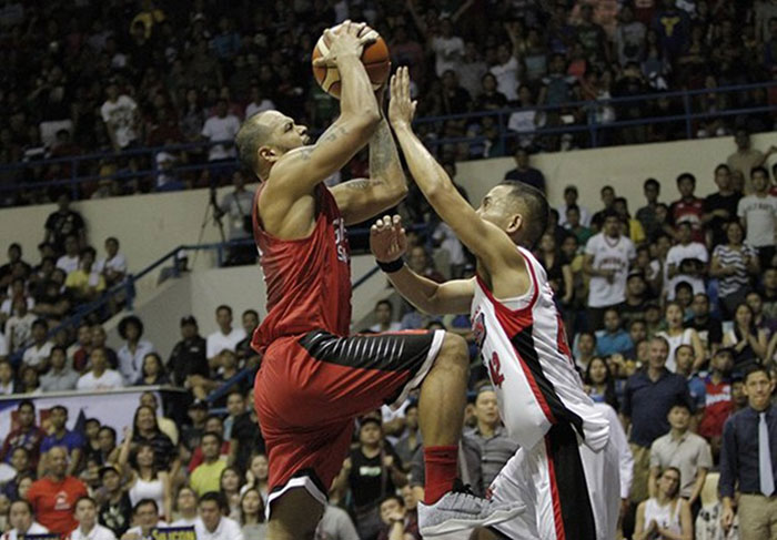 Ginebra's Sol Mercado challenges the defense of Alaska's Jvee Casio as he drives to the basket in their PBA Philippine Cup quarterfinals match at the Ynares Center in Antipolo City on Sunday night.