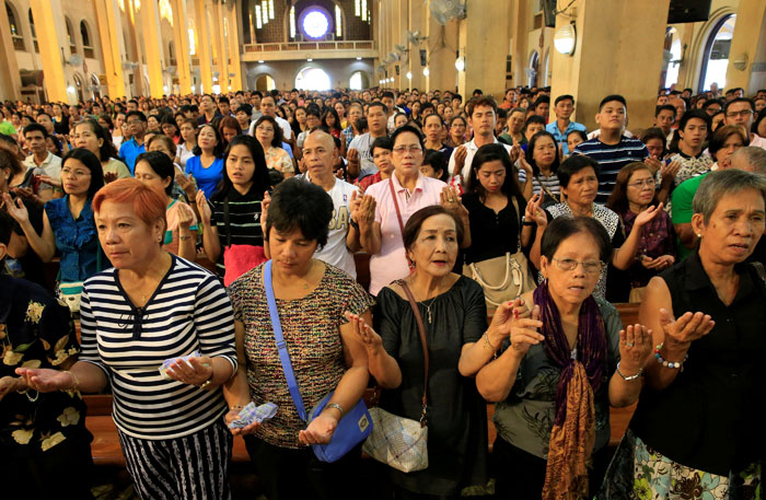 Filipino churchgoers hold hands while singing a religious song after Rev. F. Carlos Ronquillo (not in photo) talks about a pastoral letter from the Catholic Bishops' Conference of the Philippines (CBCP) about the drug war of President Rodrigo Duterte during a mass at the Redemptorist church in Paranaque city, metro Manila, Philippines. — Reuters