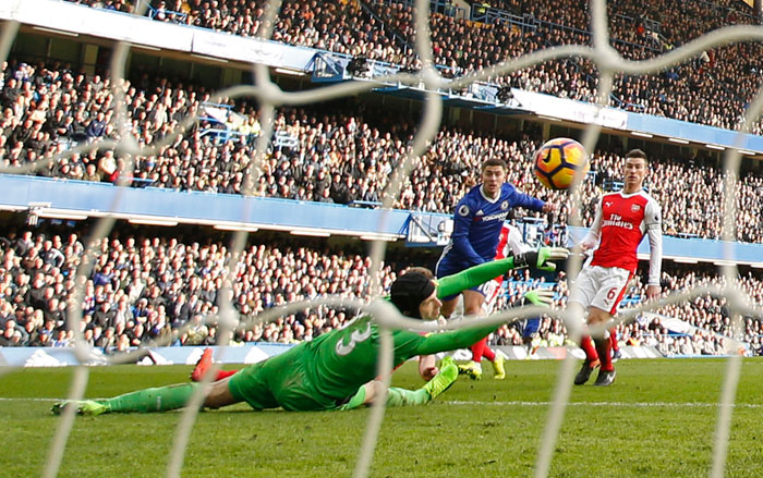 Chelsea's Eden Hazard scores their second goal against Arsenal during their Premier League match at Stamford Bridge Saturday. — Reuters