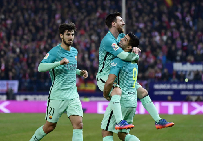 Barcelona’s Lionel Messi (C) celebrates a goal with Luis Suarez (R) beside Andre Gomes during the Spanish Copa del Rey (King’s Cup) semifinal first leg match against Atletico de Madrid at the Vicente Calderon Stadium in Madrid Wednesday. — AFP