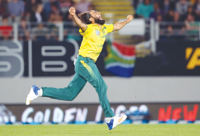 Imran Tahir of South Africa celebrates after taking the wicket of Luke Ronchi of New Zealand during their T20 International cricket match at Eden Park in Auckland Friday. — AFP