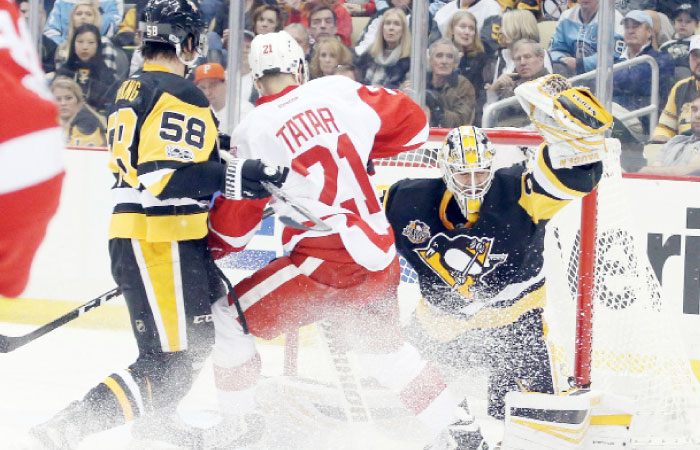 Pittsburgh Penguins goalie Matt Murray (30) makes a glove save as Penguins defenseman Kris Letang (58) defends Detroit Red Wings left wing Tomas Tatar (21) during the second period at the PPG PAINTS Arena. — Reuters