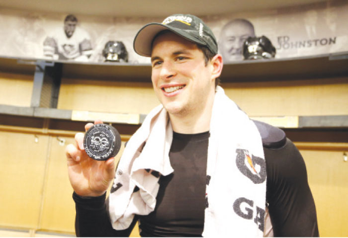 Pittsburgh Penguins’ center Sidney Crosby poses with the puck used for his 1000th career NHL point against the Winnipeg Jets at the PPG PAINTS Arena in Pittsburgh Thursday. — Reuters