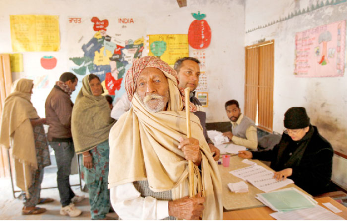 A man looks on as he arrives to cast his vote inside a polling station during the state assembly election in the northern state of Punjab, in the village of Nada, India, on Saturday. — Reuters