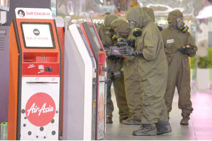 Members of Malaysia’s Hazmat team conduct a decontamination operation at the departures terminal of the Kuala Lumpur International Airport 2 (KLIA 2) in Sepang on Sunday. — AFP
