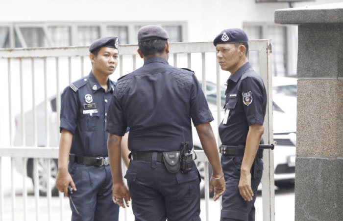 Police officers patrol outside the forensic department at Kuala Lumpur Hospital in Kuala Lumpur, Malaysia, on Tuesday. — AP