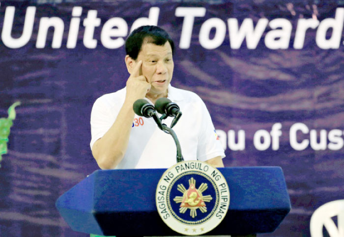 Philippine President Rodrigo Duterte gestures while delivering a speech during the 115th founding  anniversary of the Bureau of Customs in metro Manila, Phillippines on Wednesday. — Reuters