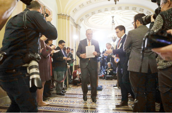 Senate Minority Leader Chuck Schumer, center, departs after speaking to the media on Capitol Hill following a policy lunch in Washington D.C. on Tuesday. — AFP