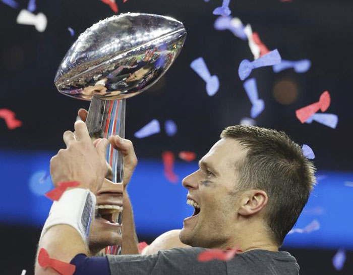 New England Patriots' quarterback Tom Brady is reflected multiple times in the Vince Lombardi trophy as he celebrates after his team defeated the Atlanta Falcons to win Super Bowl LI in Houston, Texas, U.S., February 5, 2017. — Reuters