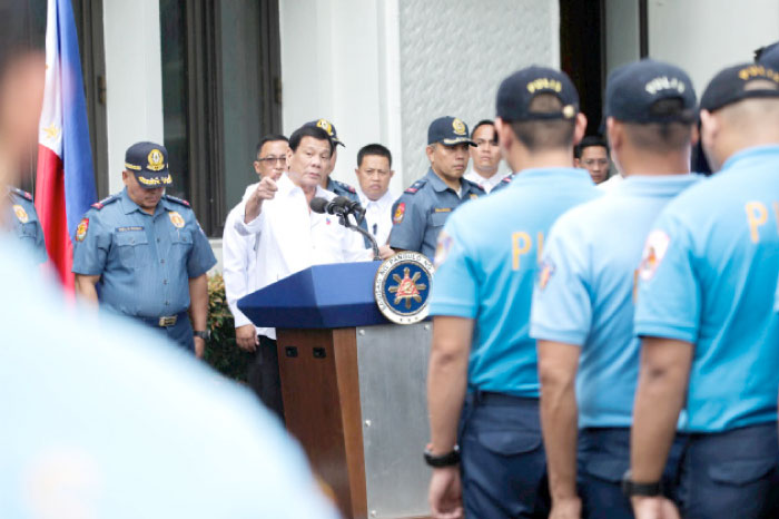 Philippine President Rodrigo Duterte speaks while talking to police officers who are under investigation for various infractions during a meeting at the Malacanang presidential palace in metro Manila, Philippines on Tuesday. — Reuters