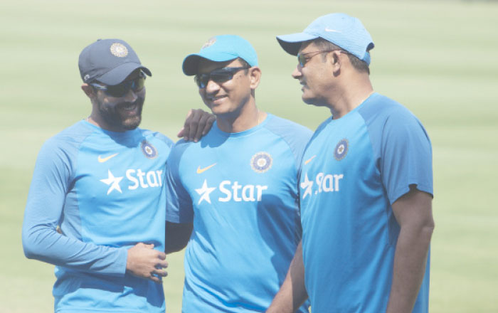 Indian cricket coach Anil Kumble, right, batting coach Sanjay Bangar, center, and player Ravindra Jadeja share a moment during a training session prior to their Test cricket match against Bangladesh in Hyderabad, India, Tuesday. — AP
